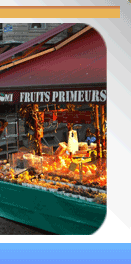 Vibrant fruit stall with fresh oranges at Rue Mouffetard market in Paris
